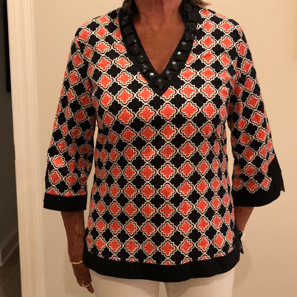 Top in orange, black & white.  Black trim size medium but runs very small